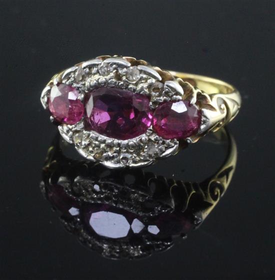 An early 20th century 18ct gold, ruby and diamond oval cluster ring, size K.